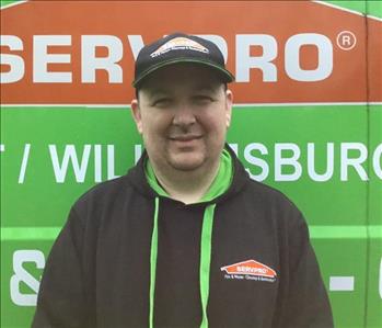 Charlie standing in front of a Servpro Vehicle