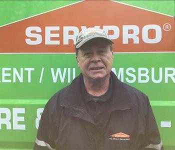 Tommy in front of a Servpro vehicle