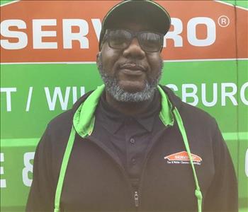 Rickey standing in front of a servpro truck